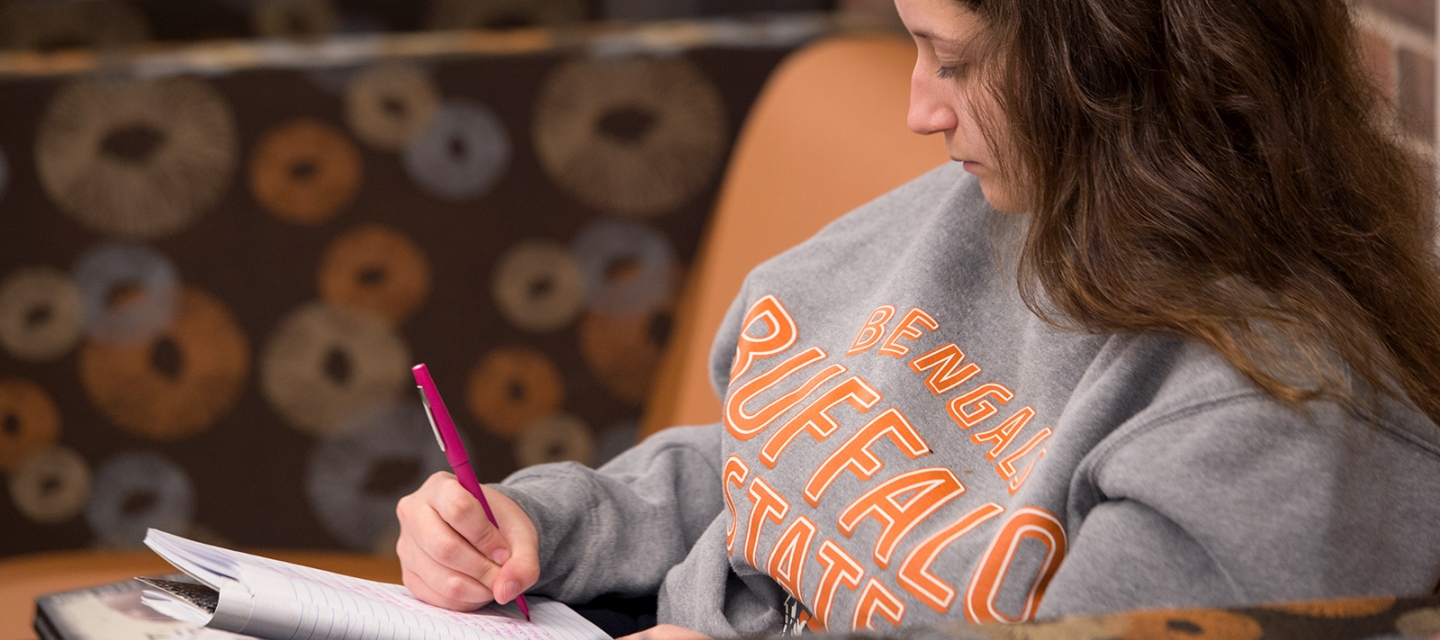 Student writing in a notebook